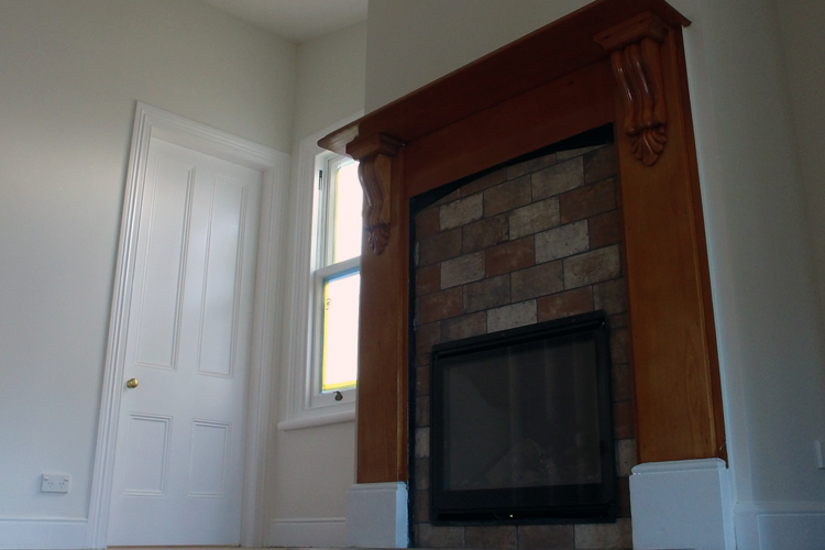 white door and fireplace with white wooden window